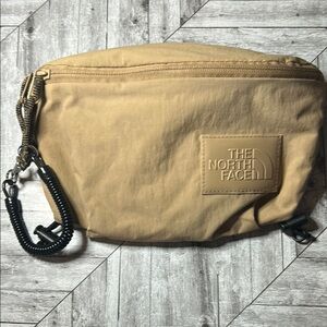 The North Face Never Stop Tan Belt Bag with Durable Fabric and Zipper Closure